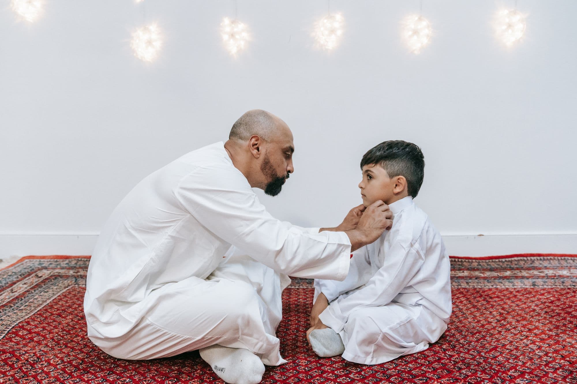 A father preparing his son for prayer